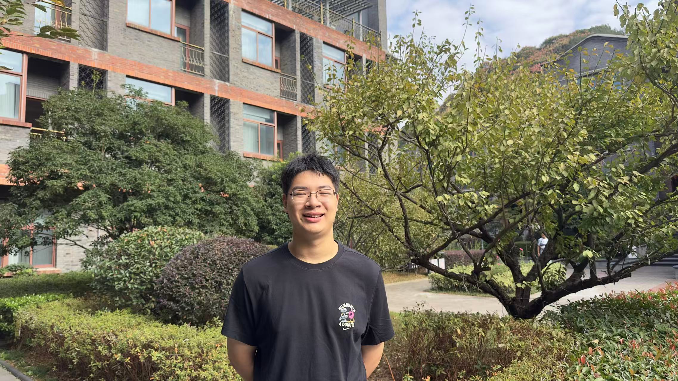 Zhang Zhenming smiling outdoors